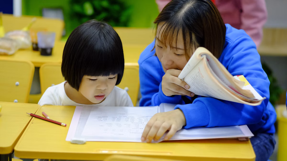 An educator gently guiding a child one-on-one